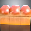 Three Orange Dome Shaped Pastry Desserts With Square Base And Smooth Glossy Surface