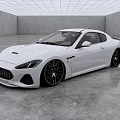 White Maserati Coupe With Sleek Exterior Design And Black Alloy Wheels In Modern Indoor Space