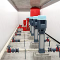 Industrial Fire Fighting Equipment with Red Pumps Pipes and Valves in Facility Room