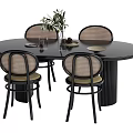 Black Round Dining Table Set With Rattan Backrest Chairs And Green Plant Centerpiece