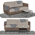 Beige Fabric Two Seater Sofa With Gray Blanket And Small Coffee Table