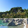 Scenic Coastal Landscape With Blue Sky Green Vegetation Palm Trees Rocks And Sandy Beach