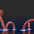 Red Dragon Shaped Art Installation with Curved Body and Illuminated Base against Dark Background