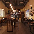 Cozy Bar Interior With Wooden Counter High Stools Hanging Lights And Guitar Decor