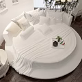 Stylish White Round Bed Interior With Chandelier Dark Curtains Wooden Floor And Wall Art
