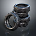 Black Stacked Tires With Tread And One Leaning On Reflective Surface