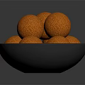 Crispy Orange Food Balls Served in Black Bowl with Crumbly Surface Texture