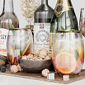 Wine Bottles And Glasses With Rose Red Wine Champagne Orange Slices Walnuts And Dried Flowers