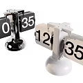 Stylish Black and White Flip Clocks with Chrome and White Bases Displaying Time