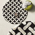 Black and White Round Rug with Braided Shaggy Texture and Green Cushion in Living Room
