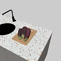 Modern Kitchen Faucet Over Black Sink On Terrazzo Countertop With Eggplants On Cutting Board