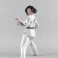 Woman In White Taekwondo Uniform With Black Belt Performing Martial Arts Moves On Gray Background