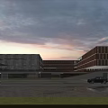 Modern School Building With Glass Facade Sunset Sky Cars And Green Grass Lawn