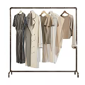 Trendy Clothes On Metal Rack Featuring Striped Dress Coat And Neutral Shirts