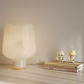 Modern White Glass Table Lamp with Decorative Figurines on Stacked Books