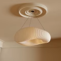 Pleated Beige Fabric Chandelier With Curved Design Hanging From Ceiling With Circular Trim