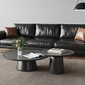 Modern Black Leather Three Seater Sofa With Brown Cushions And Black Round Coffee Table