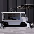 White Food Truck Outdoor Setup With Black Tables Chairs And Umbrella