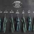 Denim Clothes Displayed On Hooks Against Dark Background 3d model