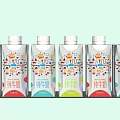 Pure Milk Drinks Six Bottles with Different Colored Labels White Caps and Light Green Background