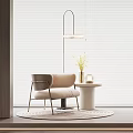 Beige Accent Chair with Metal Legs Near Round Side Table Pendant Light and Roller Blinds