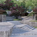 Layered Garden Landscape With Stone Steps Waterfall Walls And Red Leaved Trees