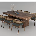 Wooden Dining Table Set With Woven Back Chairs Blue Cushions Vase And White Flowers