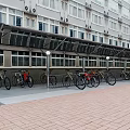 Metal Frame Bicycle Scooter Canopy Near Multi Storey Building with Brick Paved Ground