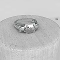 Stunning Silver Diamond Ring With Square Cut Center Stone On Concrete Pedestal