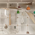 Hermes Store Window Display With Luxury Handbags White Dress And Metallic Frame Decorations