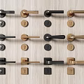 Various Styles Of Modern Door Handles In Black And Gold Displayed On Wooden Background