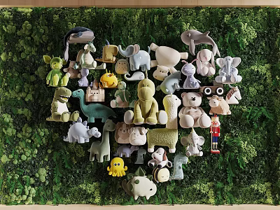 Assorted Cute Stuffed Toys Displayed on Lush Green Leafy Background 3d model