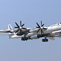 Powerful Fighter Jet Flying In Clear Sky With Four Propellers And Landing Gear