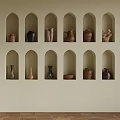 Wall Cabinets with Arched Niches Displaying Various Clay Pots and Vases in Modern Interior