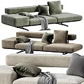 Modern Upholstered Two Seater Sofa With Green Beige Tones Plush Pillows And Soft Blanket