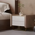 White and Beige Bedside Table with Drawers Gold Legs Glass Vase Green Plant in Bedroom