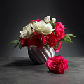 Red And White Roses In Striped Vase With Single Red Rose On Dark Table