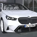 White BMW Sedan With Modern Headlights And Sleek Black Grille Design