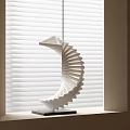 White Spiral Folded Paper Sculpture Placed On Window Sill By White Blinds