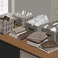Folded Brown And White Towels In Grey Storage Baskets On Wooden Table With Wall Decor