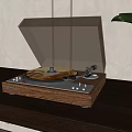 Vintage Turntable With Wooden Base And Clear Cover Playing Gold Vinyl Record On Dark Table