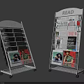 Two White Metal Magazine Racks with READ Sign Holding Magazines Newspapers and Wheels