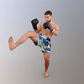 Man Performing High Kick In Boxing Gloves And Sports Shorts During Training