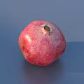 Five Fresh Red Pomegranates on Gray Surface with Natural Shine