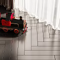 Electric Toy Train with Red and Black Design on Wooden Floor