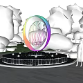 Garden Ornament Rainbow Colored Circular Sculpture with Water Fountain Surrounded by Trees and Flowers