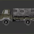 Olive Green Military Truck Featuring Canvas Covered Cargo Bed And Large Off Road Tires
