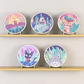 Five Round Cartoon Plates With Various Designs Displayed On Light Wooden Shelves