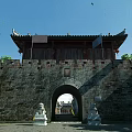 Ancient Architecture City Gate With Brick Walls Stone Lions And Traditional Roof