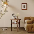 Wooden Side Table with Round Top Featuring Statue Tulips Books Near Cozy Sofa Floor Lamp